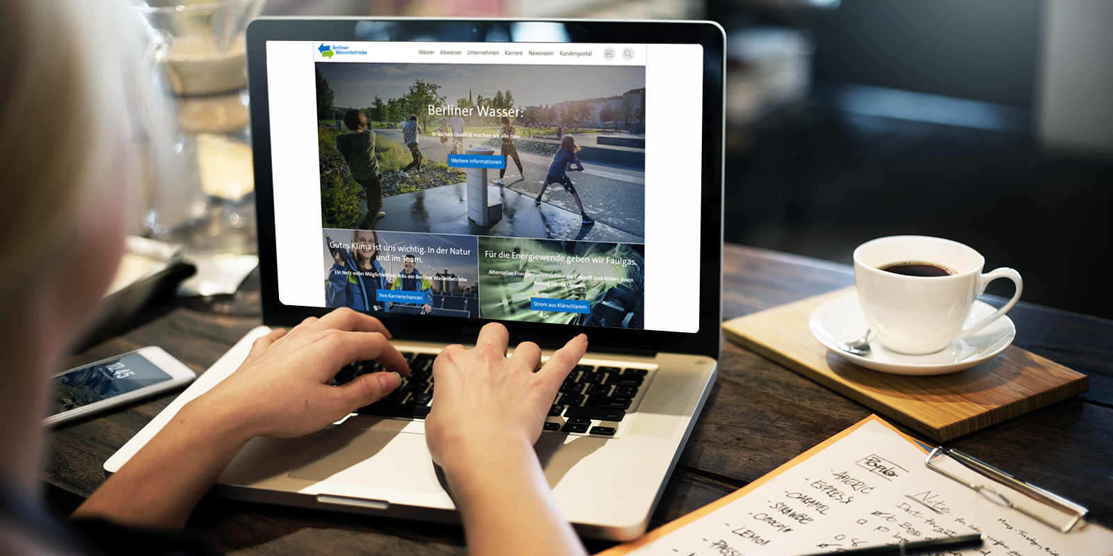 Frau sitzt am Computer auf dem die Webseite der Berliner Wasserbetriebe zu sehen ist