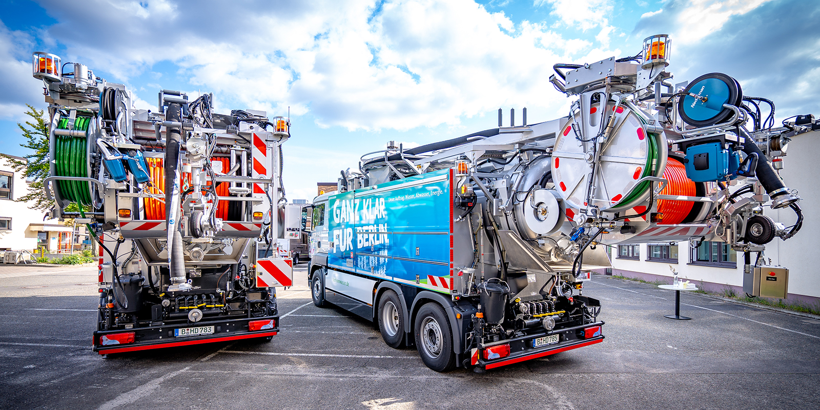 Zwei Kanalreinigungsfahrzeuge stehen auf einem Betriebshof